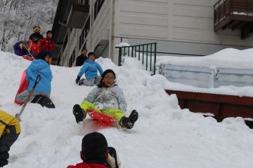 <p>Taking a quick break to sled down the slopes</p>