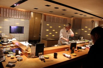 <p>The chef working in front of counter customers</p>