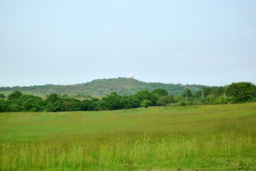 <p>Across the meadow, you can see the radar observatory of Mt. Monomi</p>