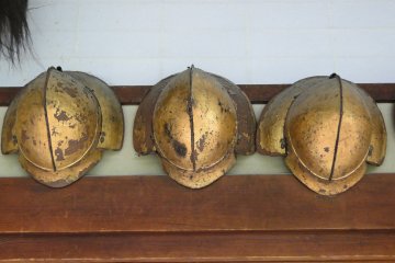 <p>Old helmets hanging in the estate's main hallway</p>