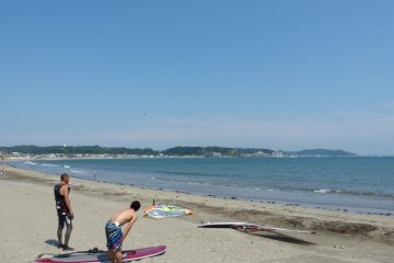 Surfers limbering up before entering the water
