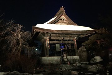 <p>The snow-topped bell pagoda, lit up in yellow</p>
