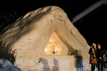 A snow replica of thatched houses.