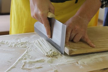 <p>Cutting the soba is a very precise process. &nbsp;First timers often cut the soba a little thick, but go back a few times and you'll be able to cut it like a pro!&nbsp;</p>