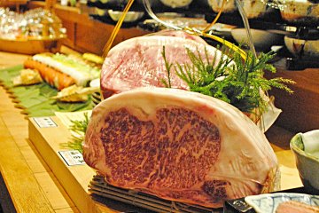 <p>Chefs prepare food in sight of the main hall</p>
