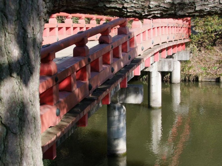 A red Japanese bridge inside the park