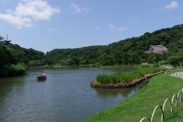 A boat on the lake with pagoda in background