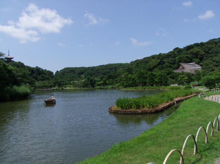 A boat on the lake with pagoda in background