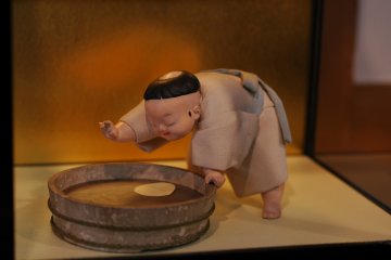 <p>The exquisite detail of this glass-encased doll shows fine craftsmanship. It's almost as if the doll is in motion.&nbsp;</p>