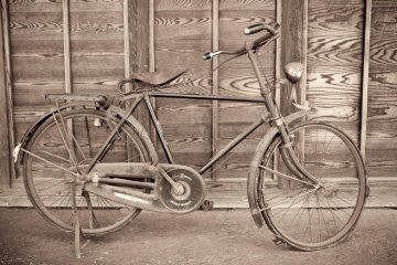 A bicycle parked outside one of the houses at the Edo Tokyo Museum