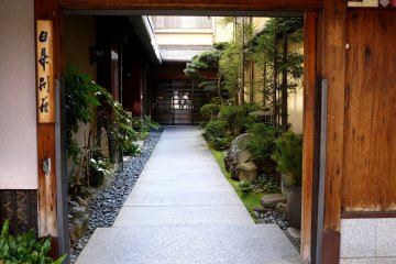 <p>Doorway from a busy city street to a quiet garden</p>