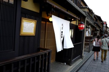 <p>A red lantern and long door curtains blowing in the breeze</p>