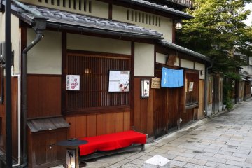 <p>Red felt covered bench outside a restaurant</p>