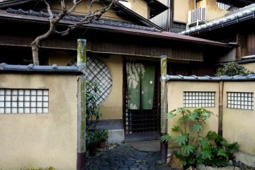<p>Path of small round paving stones leads to a curtained door</p>