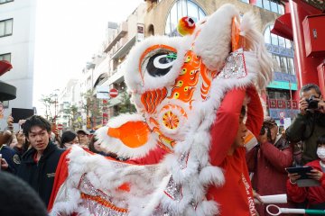 An acrobat prepares himself for the Lion Dance during the Chinese Lunar New Year festivities
