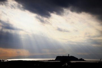 In the late afternoon the sky was covered with deep clouds and the sun was setting. Then I saw sunshine cascading through the gap of clouds. It appeared as though a god was descending surrounded by light!