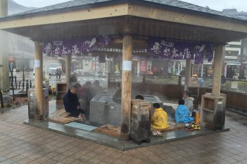 <p>But first, you will arrive at Kinugawa&nbsp;Onsen where you will catch a train to Yunishigawa Onsen. As you will have already spent two hours on the train by now, you might feel a bit hungry and tired. Why not go and grab some manju (a sweet bun with red beans filling), still fresh and warm, from one of the shops next to the station? After, head to this little hot foot&nbsp;bath just outside the station.</p>