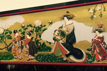 The walls in the hallway are covered with beautiful paintings.