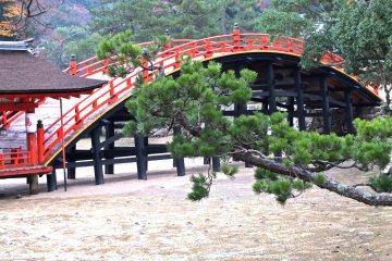 <p>An old traditional style bridge stands behind the shrine</p>