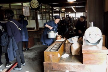 <p>Blue-clad workers in the nostalgic interior of Akafuku's store</p>