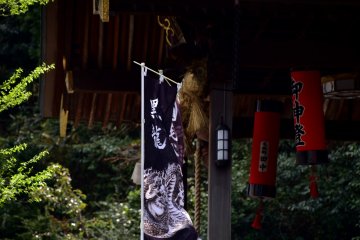 <p>Banner of Kurotatsu Shrine with black dragon painting fluttering in the strong wind</p>
