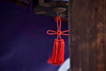 <p>Red decorative strings hanging at the entrance of the prayer hall</p>