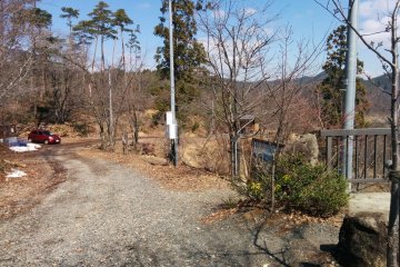 <p>A view of the unpaved road. Parking is on the far left and entrance to the "sanctuary" on the immediate right</p>