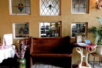 <p>Wooden seat and stained glass</p>