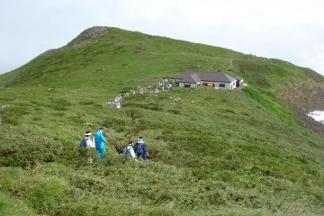 Long rows of pilgrims and hikers on the ridge of Mount Gassan