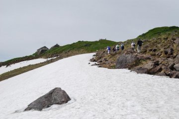 There is still snow on top of Mount Gassan in mid summer. 