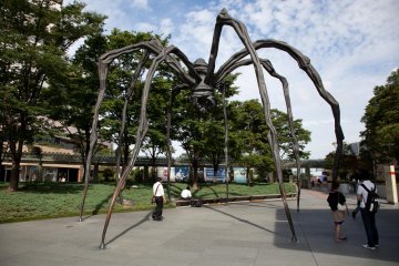 Modern art pieces are scattered around the grounds