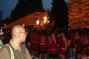 Teams carrying portable shrines called mikoshi
