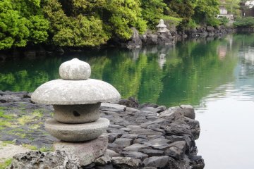 <p>A lantern overlooks the tidal Myojin Pond at the foot of Hagi's Mt Kasa</p>