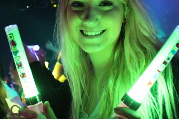 <p>Glow sticks are passed out to the audience members</p>