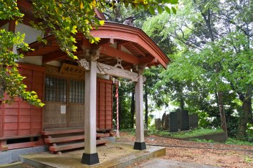 <p>The tour also included a quick stop at Ubatake Shrine. The large stones seen in the distance commemorate the annual pilgrimage to shrines located in the mountains of northern Japan.</p>