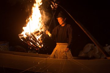<p>Stoking the fire to bring the fish to the surface</p>