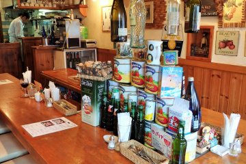 <p>The interior is warm and inviting. Guests can partially see the chef making his creations in the back.</p>