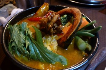 Vegetable soup curry, served with a bed of soft safron rice