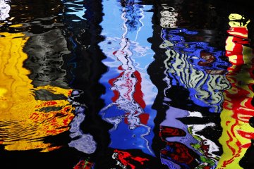<p>Neon lights reflect in the river.</p>