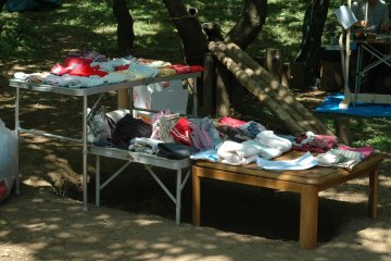 <p>Sometimes, there are children's clothes given for free. In the background is a slide made from forest materials.&nbsp;</p>