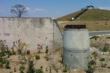 <p>A sewer and concrete foundation remain with a few other signs of debris. The height of the sewer suggests the tsunami washed a meter of ground away</p>