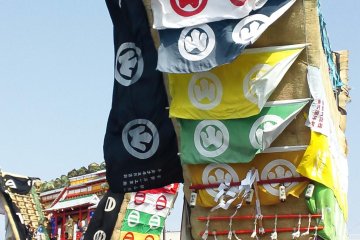 <p>Float attendants stand/crouch aboard the float</p>