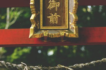 <p>The beautifully hand-made sign at the top of the small torii</p>