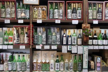 Local sake for sale—all of the bottle labels were painted by local artists