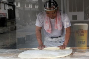 A local sweet maker prepares his pastry for the day