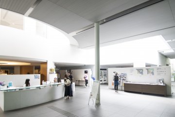 <p>The wide and open main hall is lit up by natural light filtering from above, giving it a airy and welcoming feel.</p>