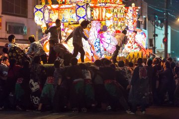 Crews push, pull, and twist the massive floats in an effort to shove the opponent back