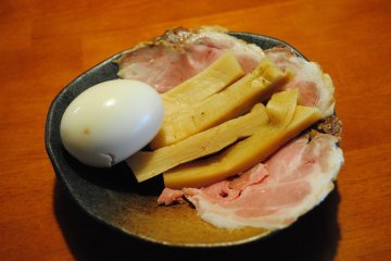 <p>You can add toppings as you like. These are an simmered egg, slices of berbecued pork, and 'menma' (Chinese seasoned bamboo shoot)</p>