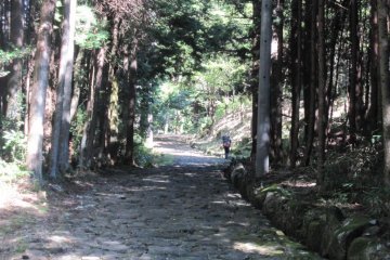 A hiker on the Cobble stone section of the Nakasendo between Ochiai and Magome