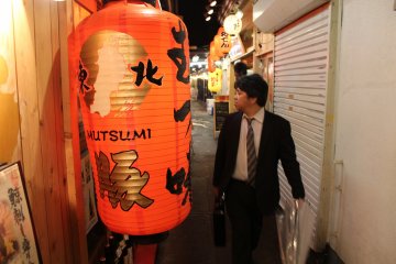 <p>Another local next to a orange glowing lantern</p>